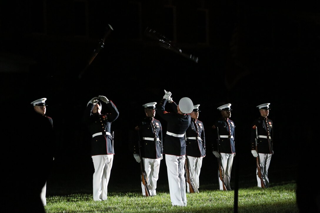 Marines with the U.S. Marine Corps Silent Drill Platoon execute their “rifle inspection” sequence during a Friday Evening Parade at Marine Barracks Washington, D.C., July 19, 2019. Medal of Honor recipient and retired CWO4 Hershel “Woody” Williams was the guest of honor for the evening and Lt. Gen. Charles G. Chiarotti, deputy commandant, Installations and Logistics, was the hosting official. (U.S. Marine Corps photo by Sgt. Robert Knapp/Released)