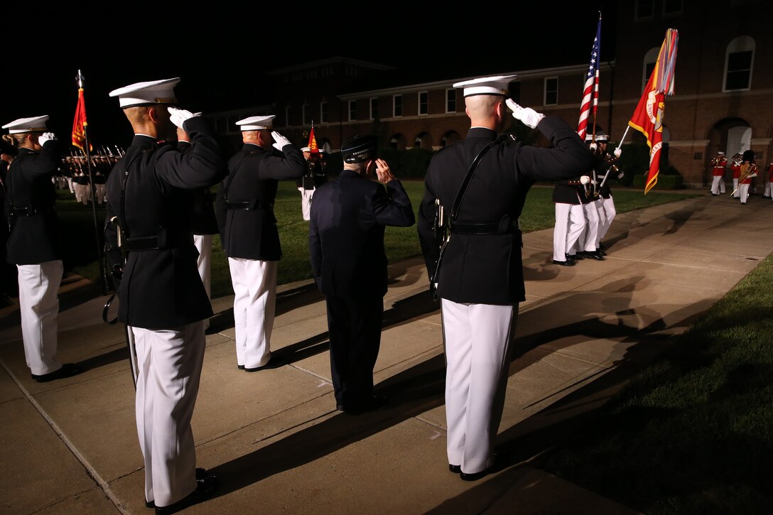 Marines with the Marine Barracks Washington parade marching staff and the guest of honor and hosting official for the evening render a salute for “pass in review” during a Friday Evening Parade at Marine Barracks Washington, D.C., July 19, 2019. Medal of Honor recipient and retired CWO4 Hershel “Woody” Williams was the guest of honor for the evening and Lt. Gen. Charles G. Chiarotti, deputy commandant, Installations and Logistics, was the hosting official. (U.S. Marine Corps photo by Sgt. Robert Knapp/Released)