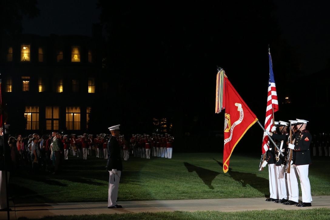 Marines with the U.S. Marine Corps Color Guard present the National Ensign during a Friday Evening Parade at Marine Barracks Washington, D.C., July 19, 2019. Medal of Honor recipient and retired CWO4 Hershel “Woody” Williams was the guest of honor for the evening and Lt. Gen. Charles G. Chiarotti, deputy commandant, Installations and Logistics, was the hosting official. (U.S. Marine Corps photo by Sgt. Robert Knapp/Released)