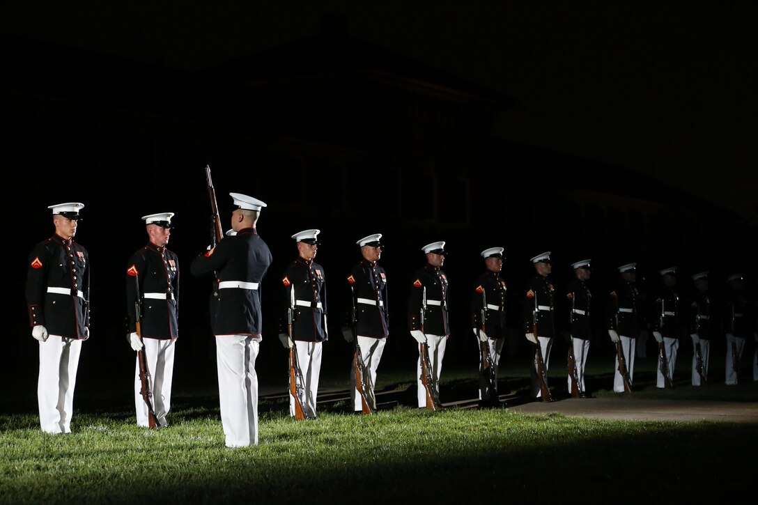 Marines with the U.S. Marine Corps Silent Drill Platoon execute their “rifle inspection” sequence during a Friday Evening Parade at Marine Barracks Washington, D.C., July 19, 2019. Medal of Honor recipient and retired CWO4 Hershel “Woody” Williams was the guest of honor for the evening and Lt. Gen. Charles G. Chiarotti, deputy commandant, Installations and Logistics, was the hosting official. (U.S. Marine Corps photo by Sgt. Robert Knapp/Released)