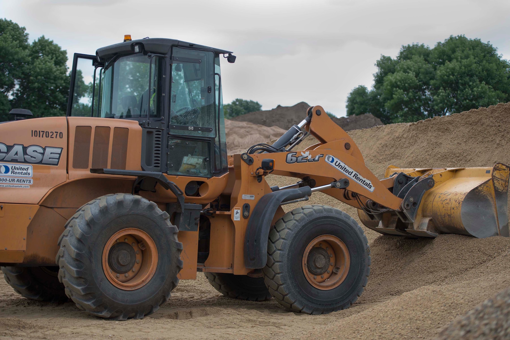 Master Sgt. Johnny Cunningham, 560th RED HORSE Squadron rotational NCO in charge, operates a front end loader at a construction site on Minneapolis-St. Paul Air Reserve Station, Minn., July 10, 2019.