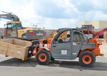 Material Examiner and Identifier Joseph Davis Jr. uses a 10k extended boom forklift at the Overseas Contingency Operations Readiness Training exercise site in Fort Custer, Michigan, in June. The annual two-week training teams agency military and civilian expeditionary personnel to support real-world military units and government customers while building field skills to bring disposal support directly to the warfighter.