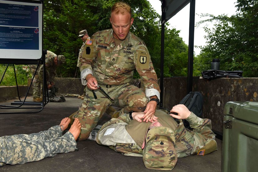 Army Staff Sgt. Erich Friedlein, with the Pennslyvania Army National Guard, prepares to apply an occlusive dressing on a fake casualty during the Army Warrior Tasks portion of the 2019 Army National Guard Best Warrior Competition at Camp Gruber, Oklahoma, July 15, 2019.