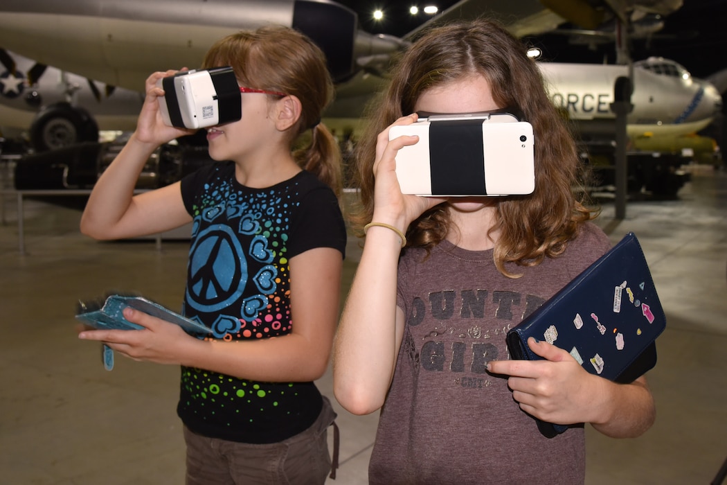 Two girls looking through VR goggles