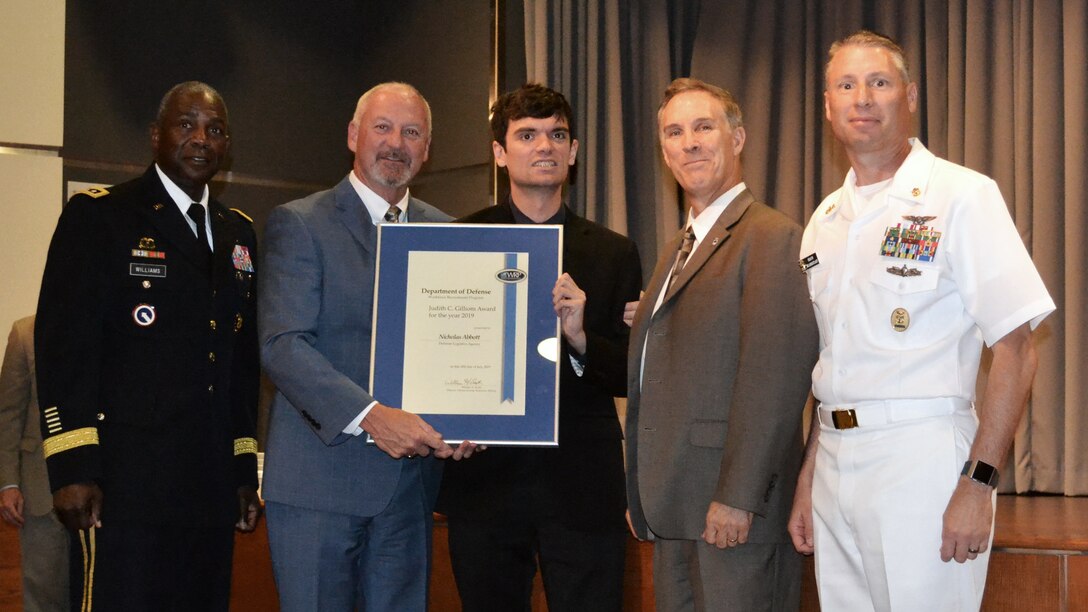 Winners and DLA representatives pose for a photo during the Defense Department’s 2018 Workforce Recruitment Program Awards ceremony July 18 in Alexandria, Virginia. From left: DLA Director Army Lt. Gen. Darrell Williams; Brian Davis, director, Defense Personnel and Family Support Center; WRP Participant of the Year Nicolas Abbott; DLA Installation Support Director Gordon Hackett; and DLA Senior Enlisted Leader Navy Command Master Chief Shaun Brahmsteadt