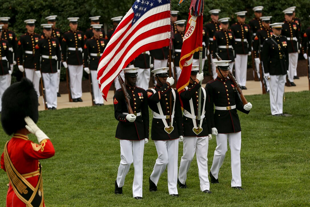 Marines with the Marine Corps Color Guard march onto the parade deck during a passage of command ceremony at Marine Barracks Washington, D.C., July 11, 2019. General Robert B. Neller relieved his duties as 37th Commandant of the Marine Corps to Gen. David H. Berger, 38th Commandant of the Marine Corps. (U.S. Marine corps photo by Pfc. Allen Sanders)