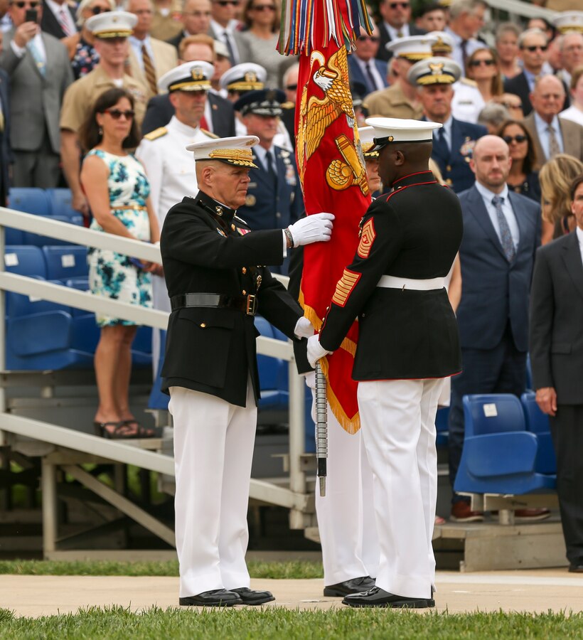 Sergeant Maj. Ronald L. Green, sergeant major of the Marine Corps, passes the Marine Corps Battle Color to Gen. Robert B. Neller, 37th Commandant of the Marine Corps, during a passage of command ceremony at Marine Barracks Washington, D.C., July 11, 2019. General Robert B. Neller relieved his duties as 37th Commandant of the Marine Corps to Gen. David H. Berger, 38th Commandant of the Marine Corps. (U.S. Marine corps photo by Pfc. Allen Sanders)