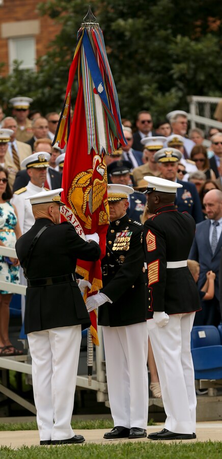 General Robert B. Neller, 37th Commandant of the Marine Corps, passes the Marine Corps Battle Color to Gen. David H. Berger, 38th Commandant of the Marine Corps, during a passage of command ceremony at Marine Barracks Washington, D.C., July 11, 2019. General Robert B. Neller relieved his duties as 37th Commandant of the Marine Corps to Gen. David H. Berger.  (U.S. Marine corps photo by Pfc. Allen Sanders)