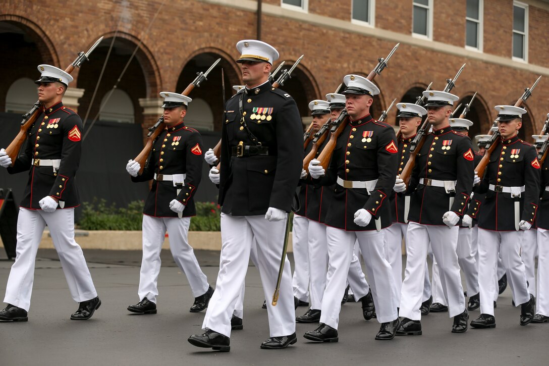 Marines with Marine Barracks Washington D.C. conduct pass in review during a passage of command ceremony at Marine Barracks Washington, D.C., July 11, 2019. General Robert B. Neller relieved his duties as 37th Commandant of the Marine Corps to Gen. David H. Berger, 38th Commandant of the Marine Corps. (U.S. Marine corps photo by Pfc. Allen Sanders)