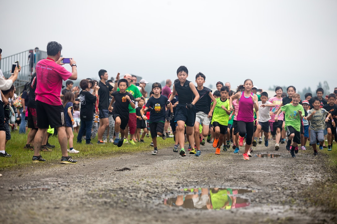 Children from the U.S. and local communities compete in Combined Arms Training Center Camp Fuji's inaugural Samurai Kids Run July 21, 2019. The 1.6 kilometer Marine Corps Community Services event was held as a chance for locals and service members to strengthen relationships through friendly competition.