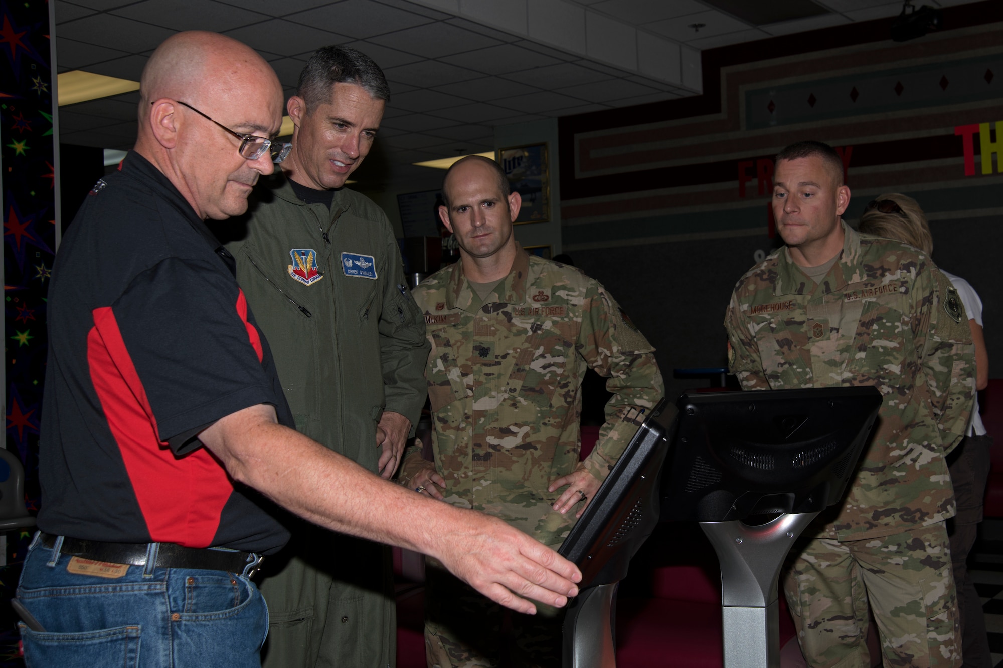 Mike Shore, 20th Force Support Squadron Shaw Lanes Bowling Center assistant manager, shows 20th Fighter Wing leaders how to begin a HyperBowling game at Shaw Air Force Base, South Carolina, July 19, 2019.