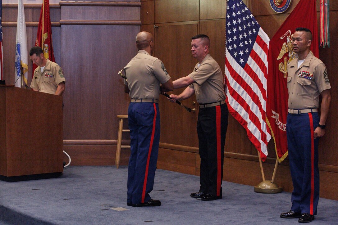 Sgt. Maj. Cortez Brown receives the sword of office from Maj. Gen. James Bierman, the commanding general of Marine Corps Recruiting Command, signifying his assumption of duties as sergeant major of Marine Corps Recruiting Command during a relief and appointment ceremony at Marine Corps Base Quantico, Virginia, July 19, 2019. (U.S. Marine Corps photo by Staff Sgt. Nygaard)