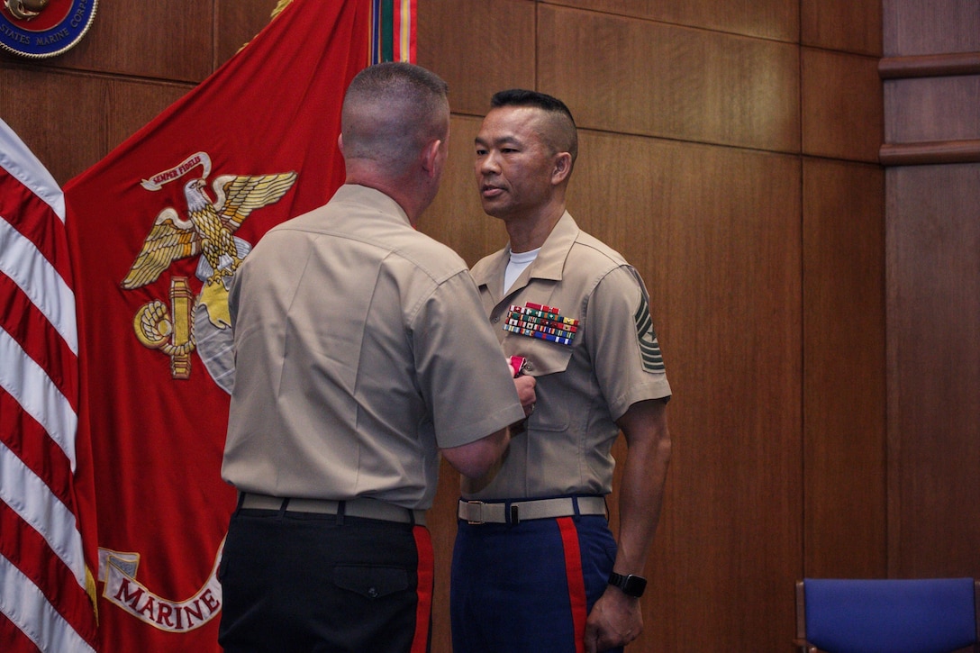 Maj. Gen. James Bierman, the commanding general of Marine Corps Recruiting Command, awards Sgt. Maj. Mike Lanpolsaen, the outgoing sergeant major of Marine Corps Recruiting Command, the Legion of Merit Medal during a relief and appointment ceremony at Marine Corps Base Quantico, Virginia, July 19, 2019. Lanpolsaen relinquished the sword of office to Sgt. Maj. Cortez L. Brown who was appointed as the new sergeant major of Marine Corps Recruiting Command. Lanpolsaen also retired from the Marine Corps after 30 years of service. (U.S. Marine Corps photo by Staff Sgt. Nygaard)