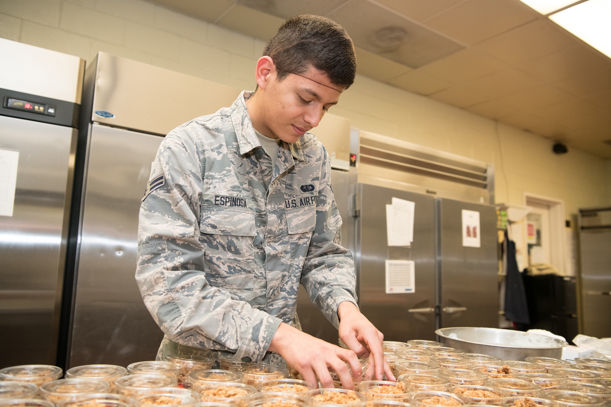 Airman 1st Class Sebastian Espinosa, 436th Force Support Squadron services journeyman, packages parfaits June 11, 2019, at the Patterson Dining Facility, Dover Air Force Base, Del. The DFAC stays open between meal times, allowing patrons to get “grab-and-go” items, like snacks, salads and prepared sandwiches. (U.S. Air Force photo by Mauricio Campino)