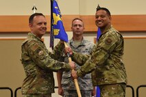 Maj. Marvin Hinkson, right, accepts command of the 341st Munitions Squadron from Col. Nathan Mitchell, 341st Maintenance Group commander, during an assumption of command ceremony July 22, 2019, at the Grizzly Bend on Malmstrom Air Force Base , Mont.