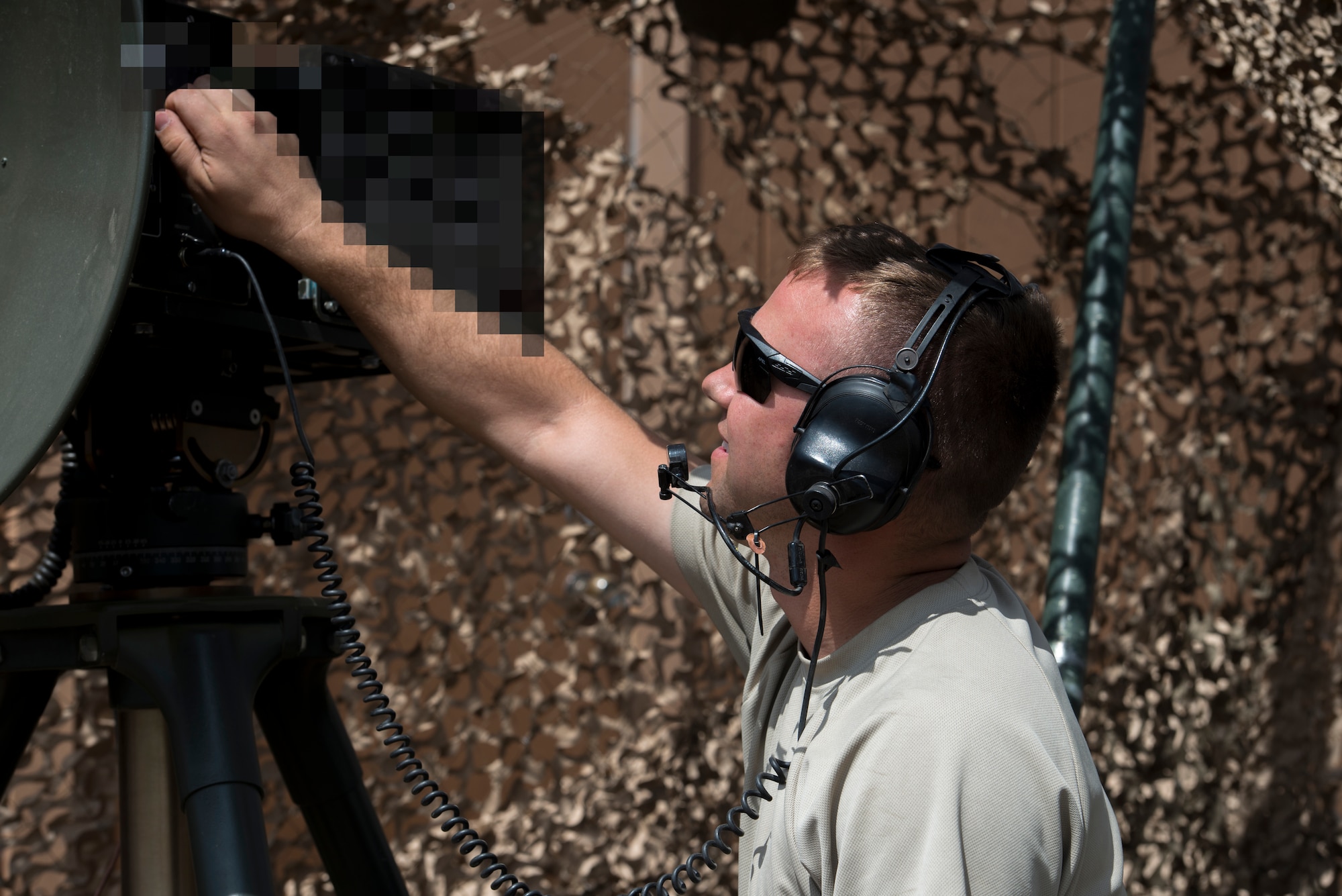 Senior Airman Jordan Jones, 726th Air Control Squadron radio frequency (RF) transmission systems technician, communicates using a Tropo Satellite Support Radio (TSSR) July 16, 2019, at Mountain Home Air Force Base, Idaho. Jones’s job is maintaining, troubleshooting, and repairing deployable communication equipment. The TSSR was blurred due to potential security risks. (U.S. Air Force photo by Senior Airman JaNae Capuno)