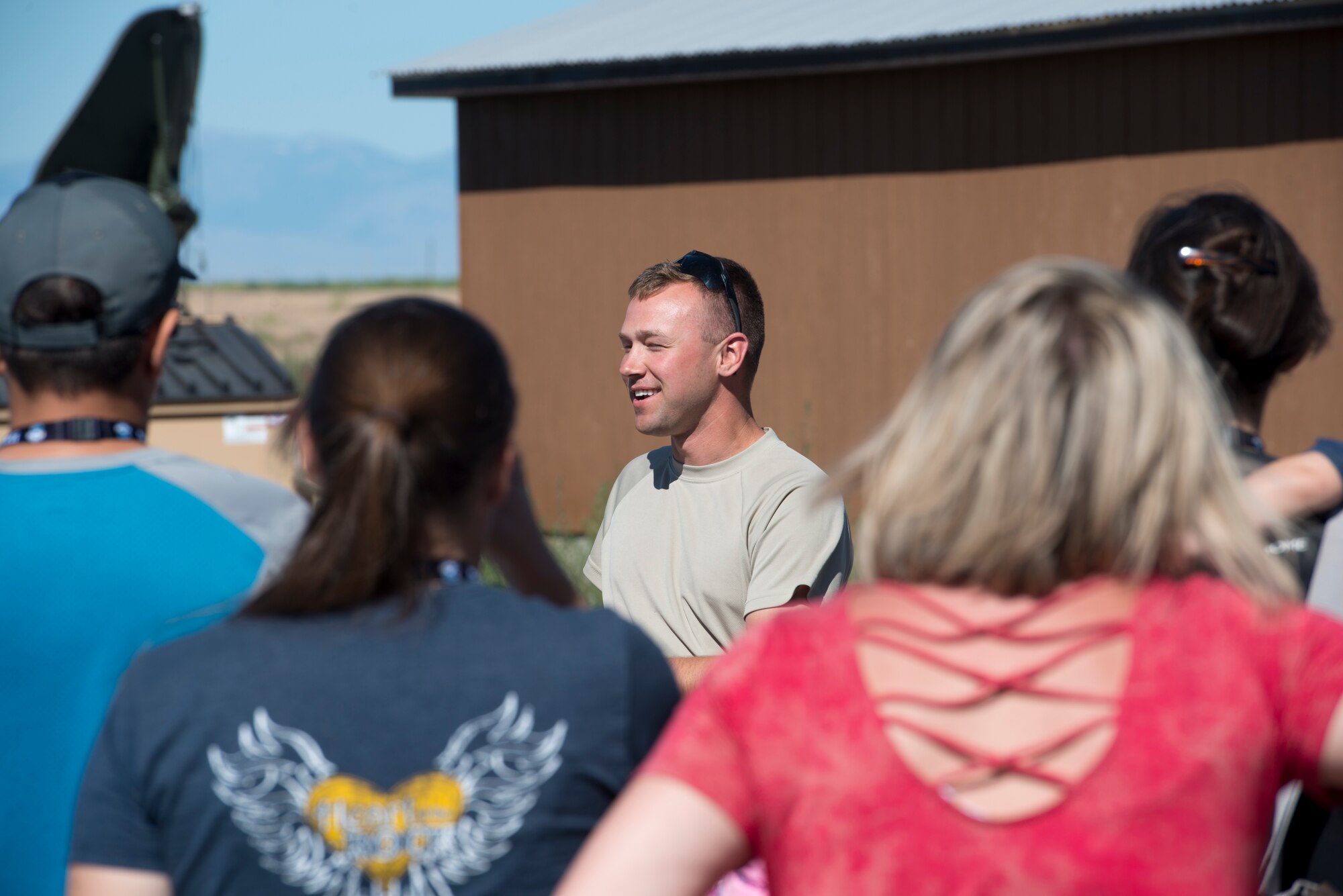 Senior Airman Jordan Jones, 726th Air Control Squadron radio frequency (RF) transmission systems technician, briefs visiting family members of the 726th ACS about his job July 16, 2019, at Mountain Home Air Force Base, Idaho. Jones’s job is maintaining, troubleshooting, and repairing deployable communication equipment. (U.S. Air Force photo by Senior Airman JaNae Capuno)