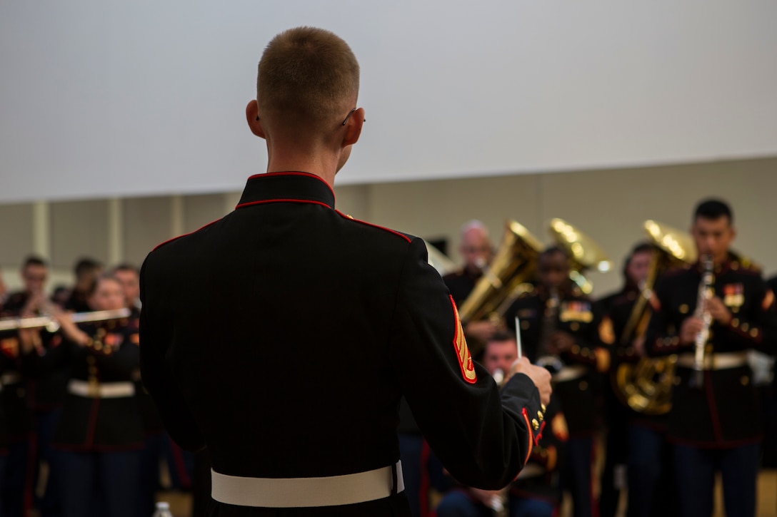U.S. Marine Corps Staff Sgt. John F. Geary, the enlisted conductor for the 3rd Marine Aircraft Wing (MAW) Band, leads the band in a practice backstage prior to performing at the California Center for the Arts, Escondido, Calif., July 4, 2019. The 3rd MAW Band spent countless hours of preparation into “An American Celebration” performance, which commemorated Independence Day. (U.S. Marine Corps photo by Lance Cpl. Levi J. Guerra)