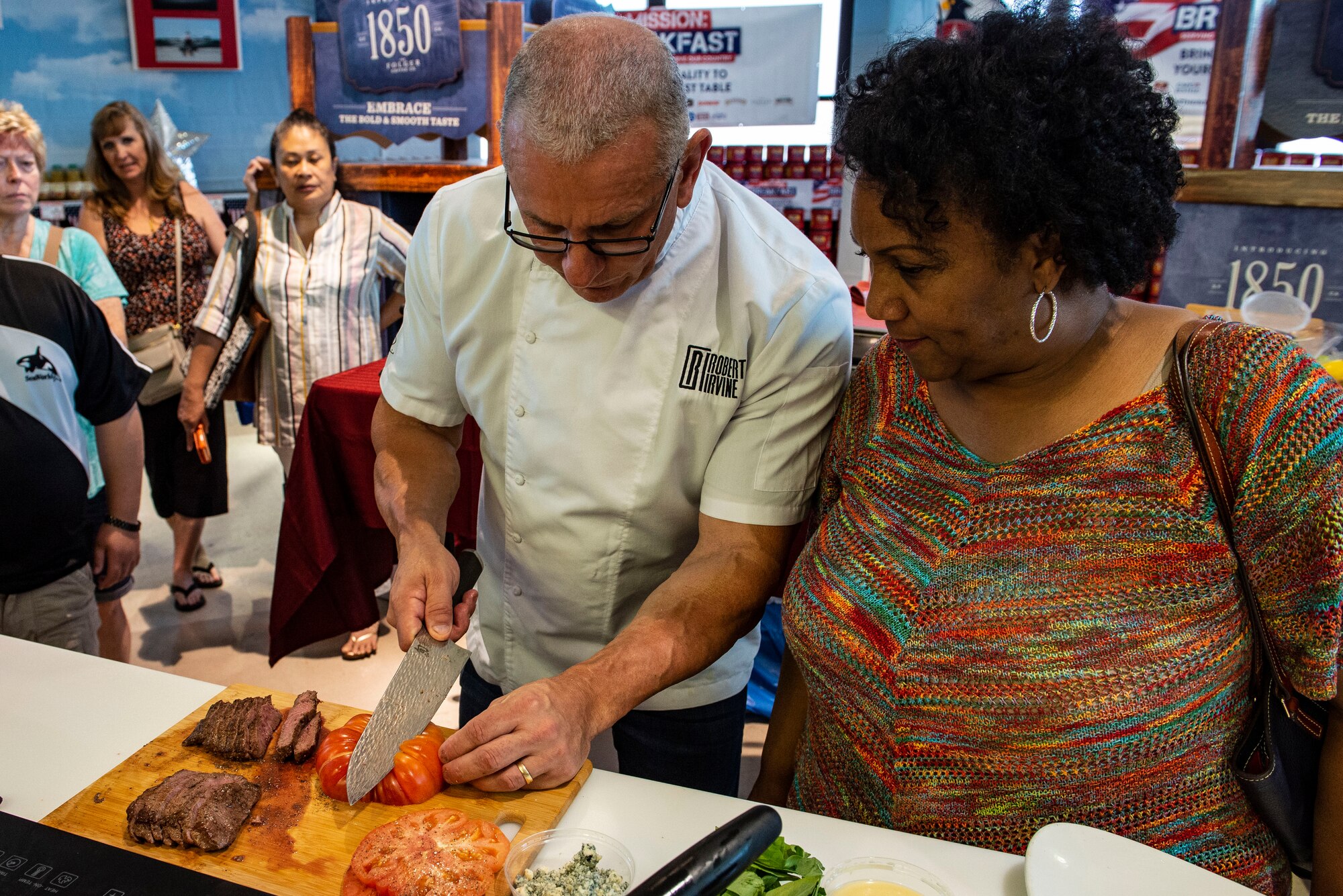Celebrity chef Robert Irvine demonstrates proper cutting techniques during his presentation at the Nellis Commissary on Nellis Air Force Base, Nev., July 19, 2019.