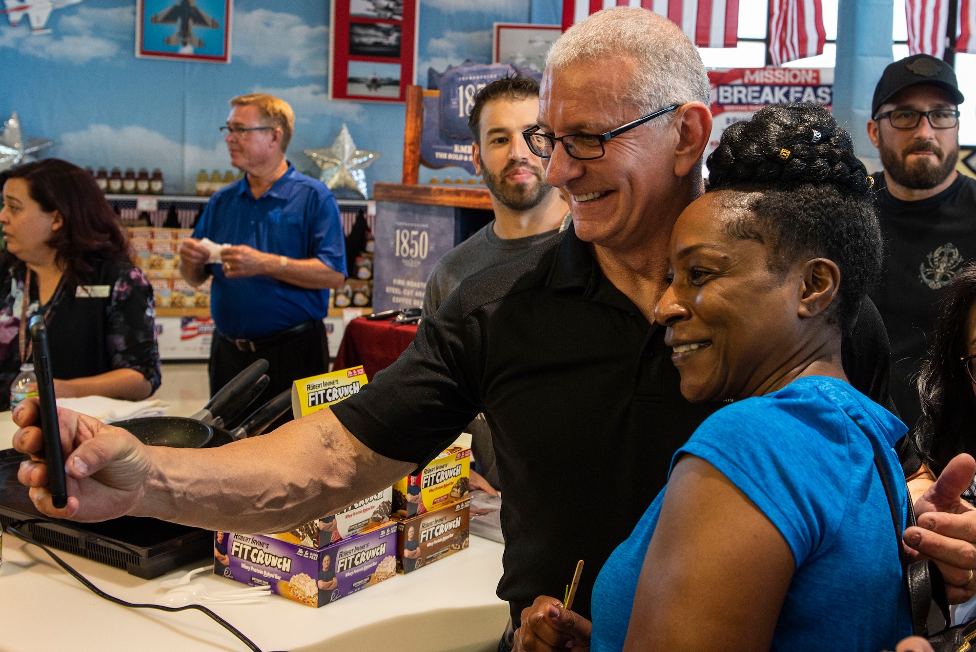 Celebrity Chef Robert Irvine poses for a photo with a commissary patron during his visit to the Nellis Commissary on Nellis Air Force Base, Nev., July 19, 2019.