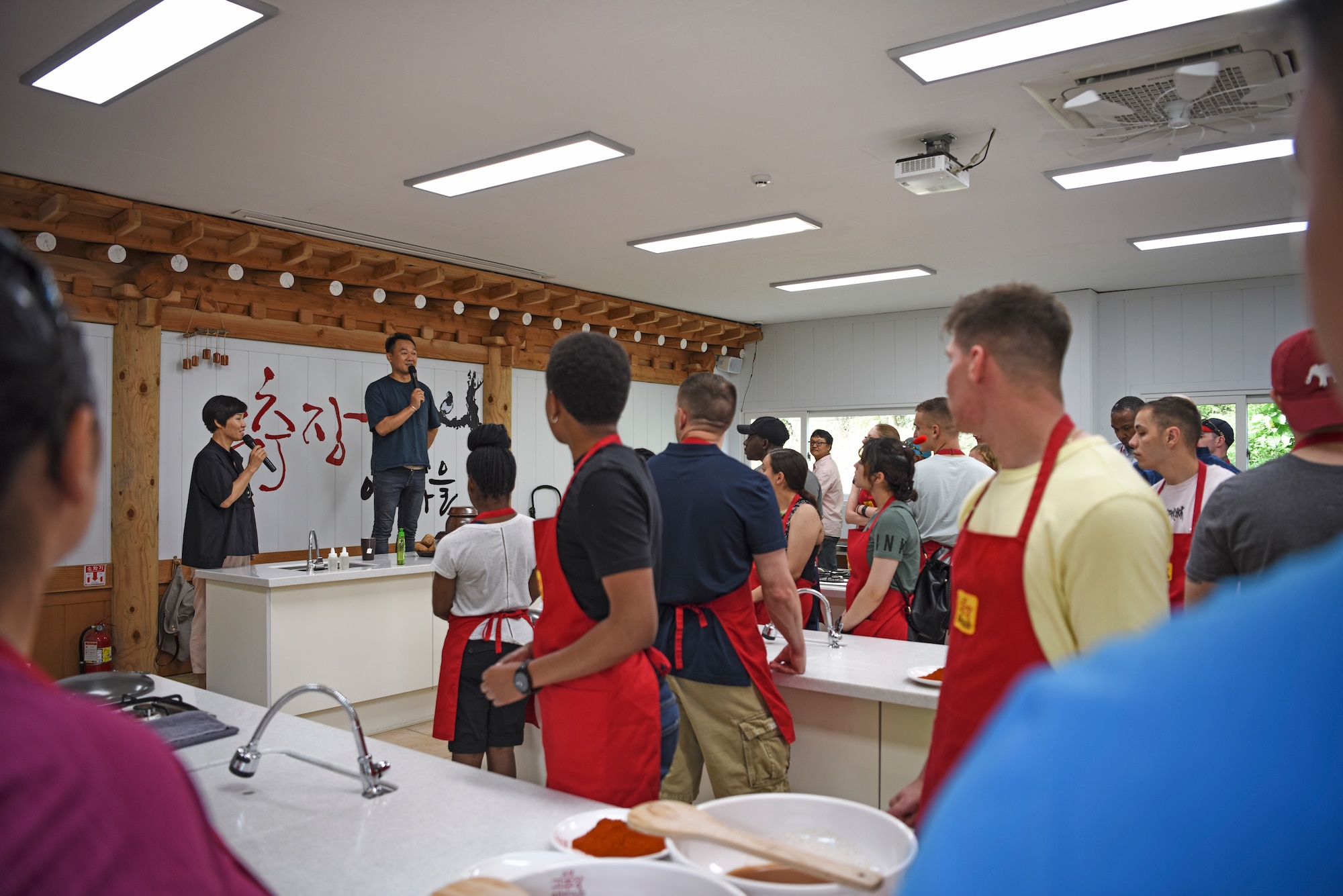 More than 50 U.S. service members prepare to cook chili paste and tokbokki, a Korean street food dish made of rice cakes, fish cakes, vegetables, chili paste and broth., during a tour at Sunchang Gochujang village, Republic of Korea, July 9, 2019. The service members received hands-on training from expert chili paste crafters on creating the Korean favorite. (U.S. Air Force photo by Staff Sgt. Mackenzie Mendez)