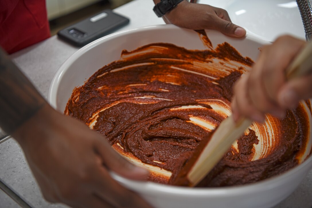 Airmen from the 51st Fighter Wing mix together the ingredients to make gochujang, or Korean chili paste, during a Ministry of National Defense tour at Sunchang Gochujang village, Republic of Korea, July 9, 2019. The Soldiers, Marines and Airmen participating in the tour also made tokbokki, a Korean street food dish made of rice cakes, fish cakes, vegetables, chili paste and broth. (U.S. Air Force photo by Staff Sgt. Mackenzie Mendez)
