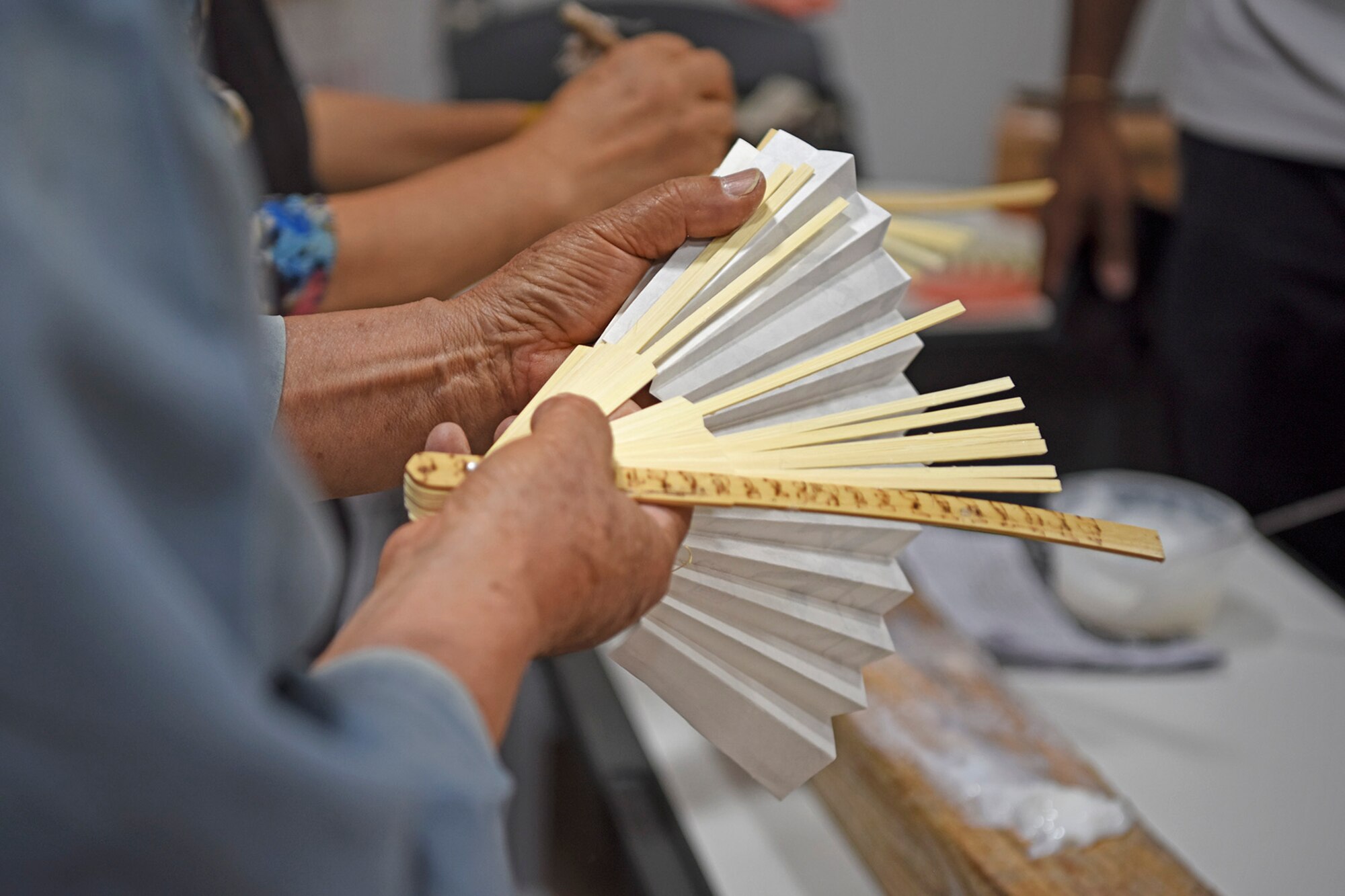 More than 50 U.S. service members received hands-on training from Juknokwon bamboo forest’s bamboo fan master during a tour at Juknokwon bamboo forest, Republic of Korea, July 10, 2019. The forest was one stop during the three-day tour hosted by ROK Ministry of National Defense. (U.S. Air Force photo by Staff Sgt. Mackenzie Mendez)