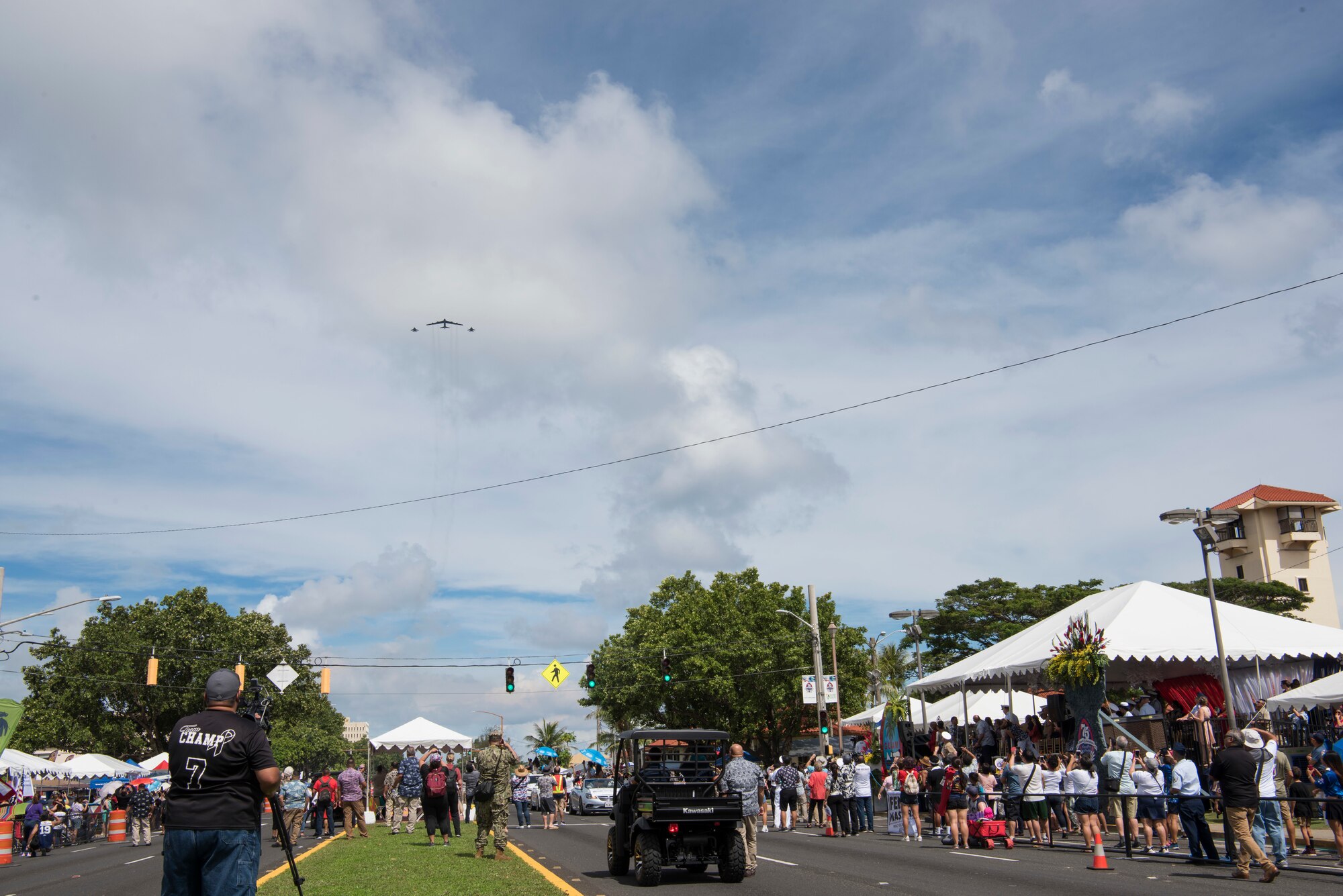 Members of the local community watch a B-52 Stratofortress and two F-15 Eagles fly over Hagatna, Guam during the 75th Liberation Day July 21, 2019.