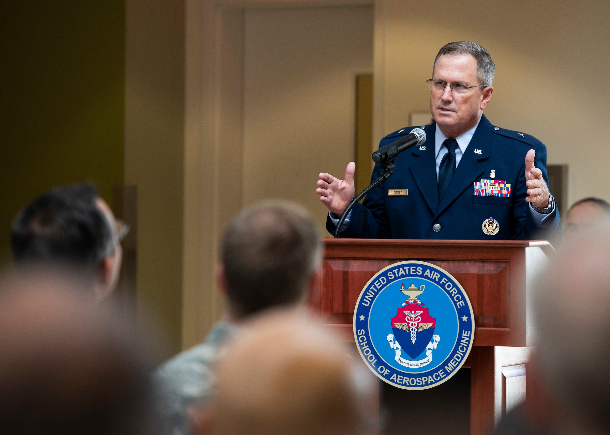 Brig. Gen. James Dienst, 711th Human Performance Wing commander, delivers opening remarks during the U.S. Air Force School of Aerospace Medicine Change of Command ceremony July 19 in the atrium of the schoolhouse. (U.S. Air Force photo/Wesley Farnsworth)