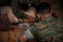 U.S. Marine Corps Maj. Zach Worth performs tactical field care while Hospital Corpsman 3rd Class Nicholas Berra Martinez assesses his performance at the end of a Tactical Combat Casualty Care course on Camp Hansen, Okinawa, Japan, July 11, 2019. The Medical Simulation Training Center trains Marines, throughout III Marine Expeditionary Force, in Combat Life Saving, TCCC and other field medical courses with the mission of eliminating preventable deaths on the battlefield. Worth, a native of The Dalles, Oregon, is an MV-22 Osprey pilot with Marine Aviation Group 36, 1st Marine Aircraft Wing. Berra Martinez, a native of Brooklyn, New York, is an instructor with the MSTC. (U.S. Marine Corps photo by Cpl. Jamin M. Powell)