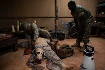 U.S. Marine Corps Sgt. Jacob Garrido, left, performs tactical field care while Hospital Corpsman 1st Class Hussein Taaha assesses his performance at the end of a Tactical Combat Casualty Care course on Camp Hansen, Okinawa, Japan, July 11, 2019. The Medical Simulation Training Center trains Marines, throughout III Marine Expeditionary Force, in Combat Life Saving, TCCC and other field medical courses with the mission of eliminating preventable deaths on the battlefield. Garrido, a native of Mangilao, Guam, is a rifleman with Expeditionary Operations Group, III MEF Information Group. Taaha, a native of Bronx, New York, is the leading Petty Officer of MSTC. (U.S. Marine Corps photo by Cpl. Jamin M. Powell)