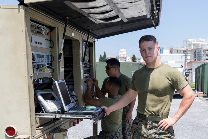 “Compared to my previous unit, 3rd Marine Logistics Group is a close knit community that focuses on MOS proficiency,” said U.S. Marine Corps Cpl. Chandler Sexton while checking communication between frequencies on Camp Kinser, Okinawa, Japan, July 15, 2019. Sexton, a native of Chesapeake, Ohio, works as a satellite operator with Communications Company, Combat Logistics Regiment 37, 3rd Marine Logistics Group.  (U.S. Marine Corps photo by Pfc. Courtney A. Robertson)