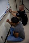 U.S. Marine Corps Pfc. Aliyah Nolan, left, and Pfc. Tyler Roberts, right, sand down a wall in preparation for painting at AmerAsian School in Okinawa during a community relations event in Okinawa, Japan, July 15, 2019. Combat Logistics Battalion 4’s chaplain’s office set up this event to help the school with summer cleaning and other various chores. Nolan, a native of Marino Valley, California, is a motor vehicle operator with 3rd Platoon, Transportation Services Company, CLB-4, Combat Logistics Regiment 3. Roberts, a native of Sacramento, California, is a motor vehicle operator with 3rd Plt., TS Co., CLB-4, CLR-3. (U.S. Marine Corps photo by Cpl. Jamin M. Powell)