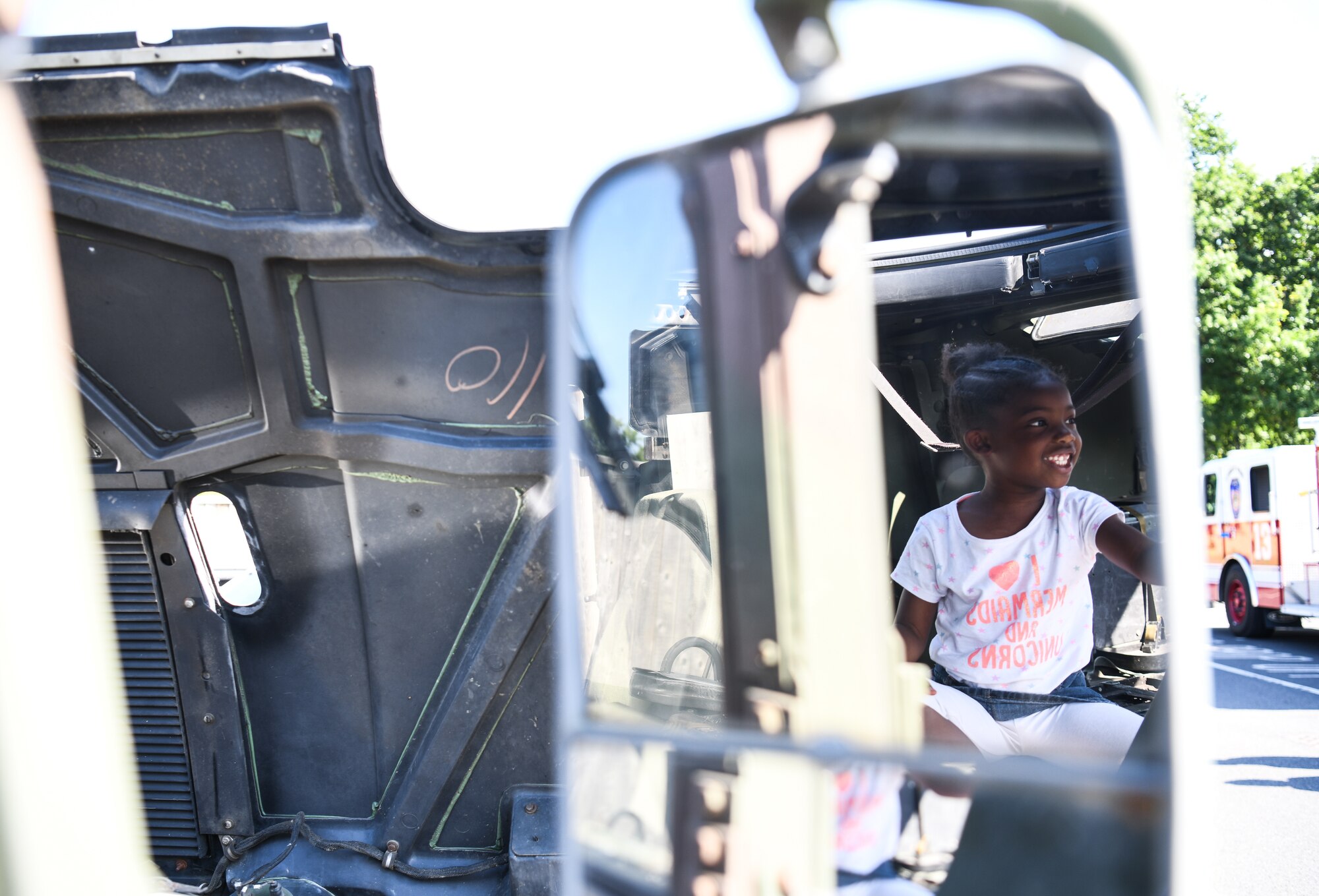 A child explores a Humvee during a vehicle display event at Royal Air Force Lakenheath, England, July  3, 2019.  The event was hosted by the 48th Logistics Readiness squadron and also included a wrecker recovery vehicle, an all-terrain forklift, patrol vehicle, an ATV and a Humvee. (U.S. Air Force photo by Airman 1st Class Shanice Williams-Jones)