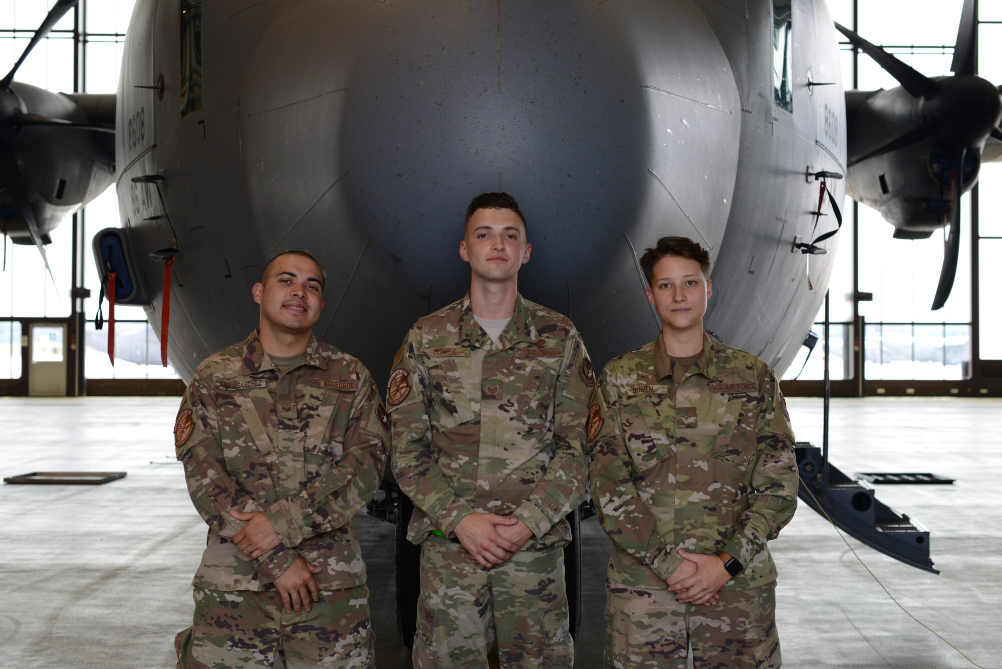 Three U.S. Air Force members from the 86th Aircraft Maintenance Squadron stand in front of a C-130J Super Hercules aircraft on Ramstein Air Base, Germany, July 18, 2019.