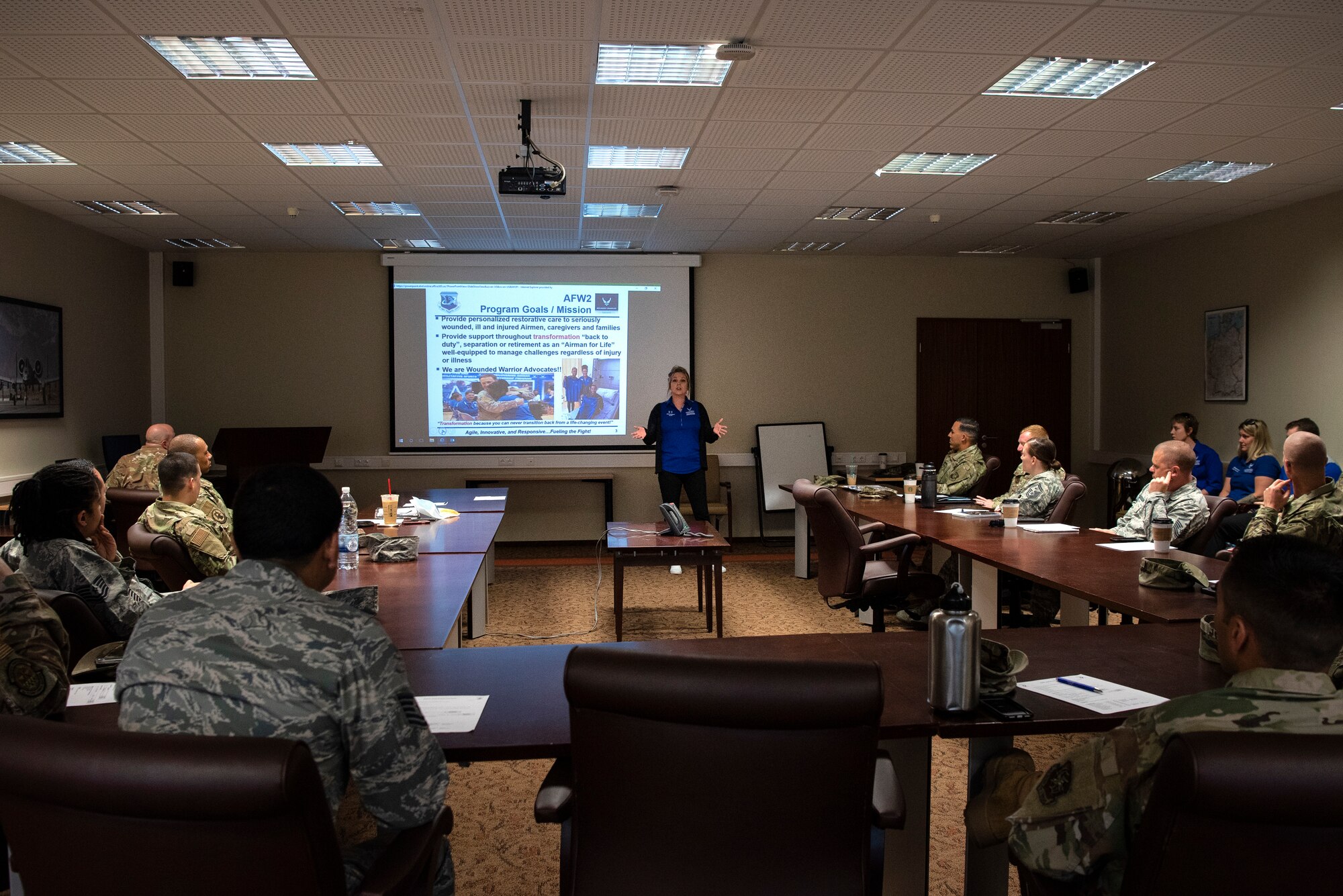 Julie Rodriguez, U.S. Air Force Wounded Warrior Program ambassador, center, speaks at a first sergeant council meeting at Spangdahlem Air Base, Germany, July 23, 2019. The Wounded Warrior team visited different units on base to discuss the program's mission and goals. The organization takes care of wounded Airmen, veterans, and their families. The goal is to leave Airmen well-equipped to manage challenges, regardless of injury or illness. (U.S. Air Force photo by Airman 1st Class Valerie Seelye)