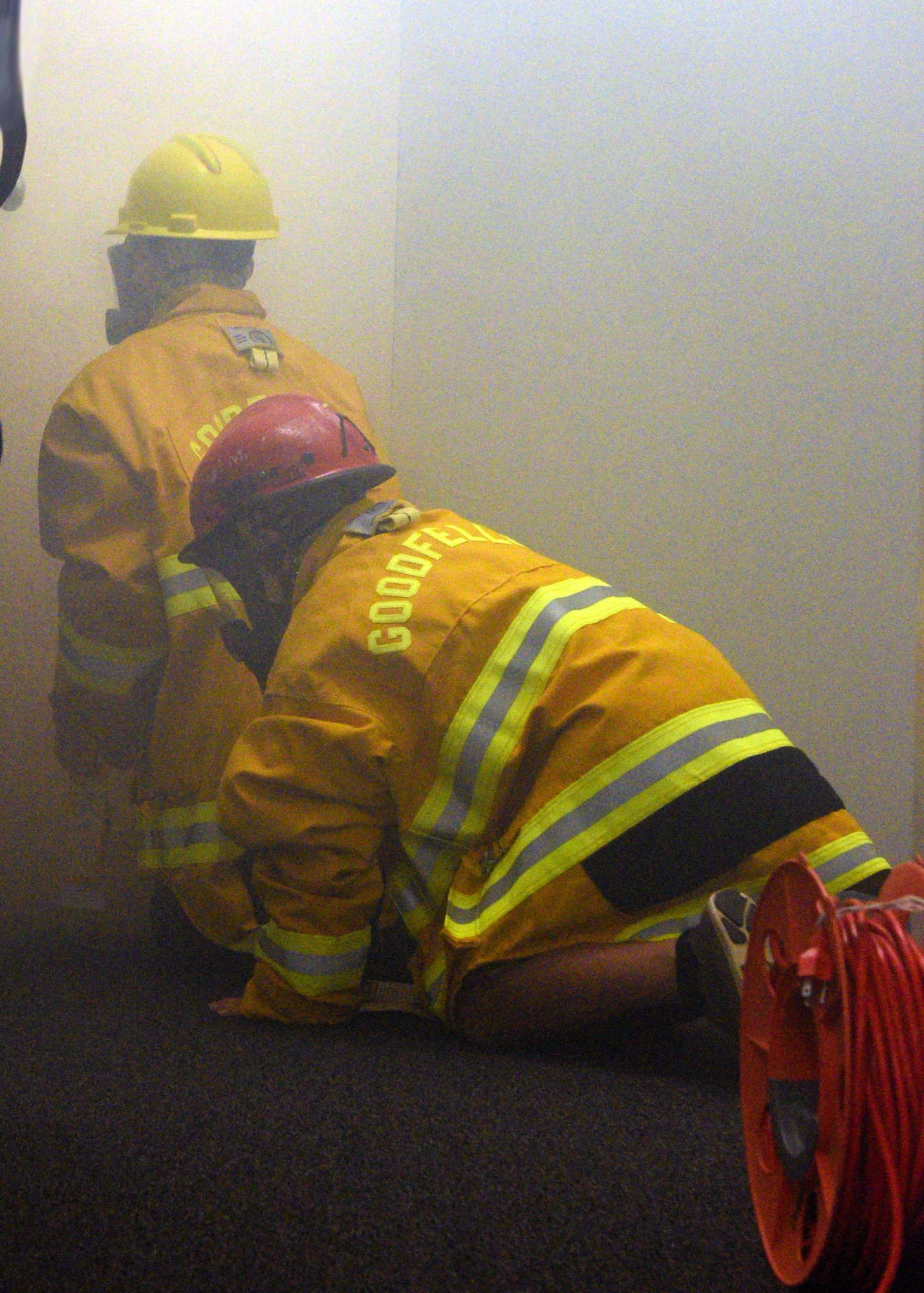 Junior firefighters donned in protective gear complete a building search and rescue drill at the Goodfellow Air Force Base Fire Department on Goodfellow Air Force Base, Texas, July 18, 2019. They learned the importance of using a ‘buddy system’ to ensure that they made it in and out of the simulated environment safely. (U.S. Air Force photo by Airman 1st Class Robyn Hunsinger/Released)