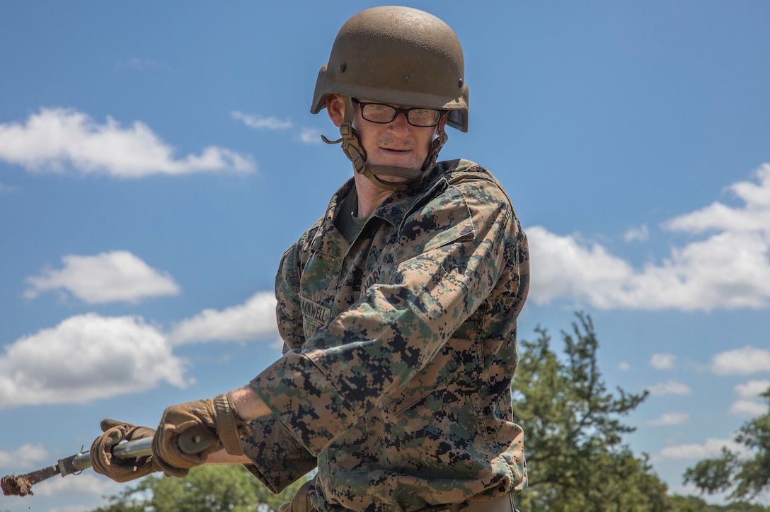 U.S. Marine Lance Cpl. Justice Blackwell, a ground radio repairman with Headquarters Battery, 2nd Battalion, 14th Marine Regiment, 4th Marine Division, digs a fighting hole for entry control points to provide security during their annual training event Operation Zeus, Fort Hood, Texas, July 18, 2019. Annual training exercises ensure Reserve Marines are proficient and capable of successful integration with their active duty counterparts. (U.S. Marine Corps photo by Cpl. Serine Farahi)