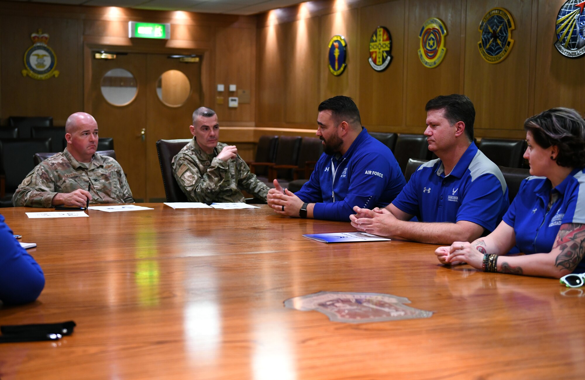 Air Force Wounded Warrior team members Brad Britt, Beau Jones and Hannah Stolberg, brief Col. William Marshall, 48th Fighter Wing commander, and Chief Master Sgt. Marc Schoellkopf, 48th FW command chief, at Royal Air Force Lakenheath, England, July 15, 2019. The program personnel visited RAF Lakenheath and RAF Mildenhall July 15-16 to share their experiences with Airmen and explain how the program benefits wounded warriors. (U.S. Air Force photo by Staff Sgt. Alex Echols)