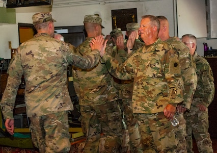 ILNG leadership high-five Soldiers following the Deployment Ceremony