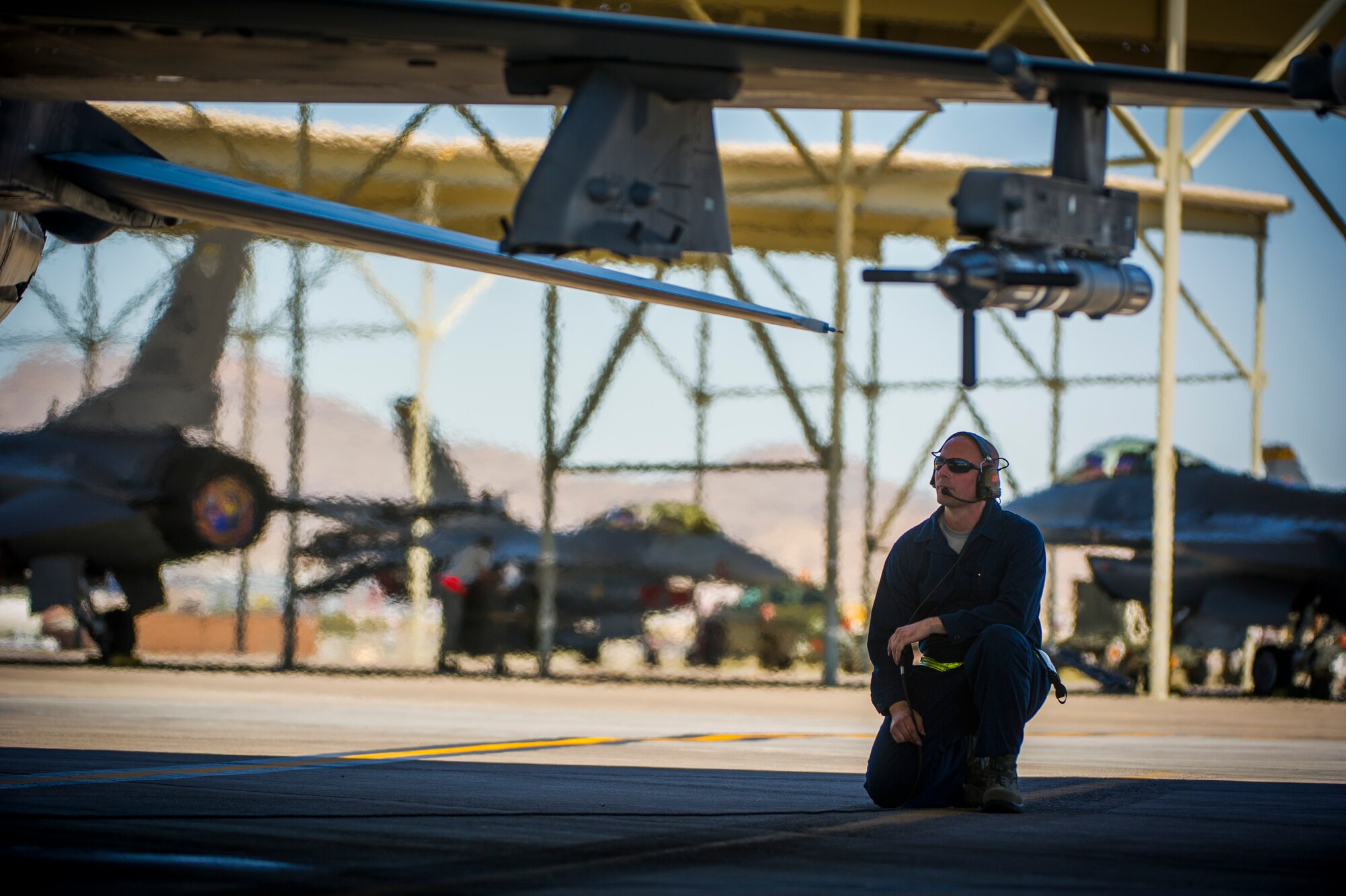 Airman 1st Class Russell Lee, 57th Aircraft Maintenance Squadron crew chief, conducts pre-flight checks July 16, 2019, at Nellis Air Force Base, Nev. Red Flag focuses on the application of core missions to include Command and Control, Intelligence Surveillance, Strike and Personnel Recovery and how to work with Coalition counterparts to ensure success. The 706th Fighter Squadron oversees Air Force Reserve Command members assigned to the U.S. Air Force Warfare Center, supporting missions in its 57th Wing, 53rd Wing and 505th Command and Control Wing. Pilots assigned to the 706 FS fly an array of aircraft to include the F-15C, F-15E, F-16, F-22 and F-35 aircraft. To prepare combat air forces, joint and allied crews with realistic training, pilots in the 706 FS operate with the 64th Aggressor Squadron to facilitate operational threat replication, training, and feedback. The Red Flag exercise will continue through July 26, 2019.
