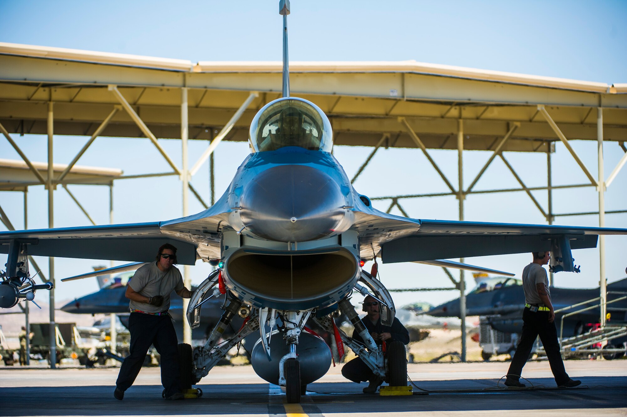 Airmen assigned to the 57th Aircraft Maintenance Squadron crew chief, conduct pre-flight checks on an F-16 fighting falcon assigned to the 64th Aggressors Squadron July 16, 2019, at Nellis Air Force Base, Nev. Red Flag focuses on the application of core missions to include Command and Control, Intelligence Surveillance, Strike and Personnel Recovery and how to work with Coalition counterparts to ensure success. The 706th Fighter Squadron oversees Air Force Reserve Command members assigned to the U.S. Air Force Warfare Center, supporting missions in its 57th Wing, 53rd Wing and 505th Command and Control Wing. Pilots assigned to the 706 FS fly an array of aircraft to include the F-15C, F-15E, F-16, F-22 and F-35 aircraft. To prepare combat air forces, joint and allied crews with realistic training, pilots in the 706 FS operate with the 64th Aggressor Squadron to facilitate operational threat replication, training, and feedback. The Red Flag exercise will continue through July 26, 2019.