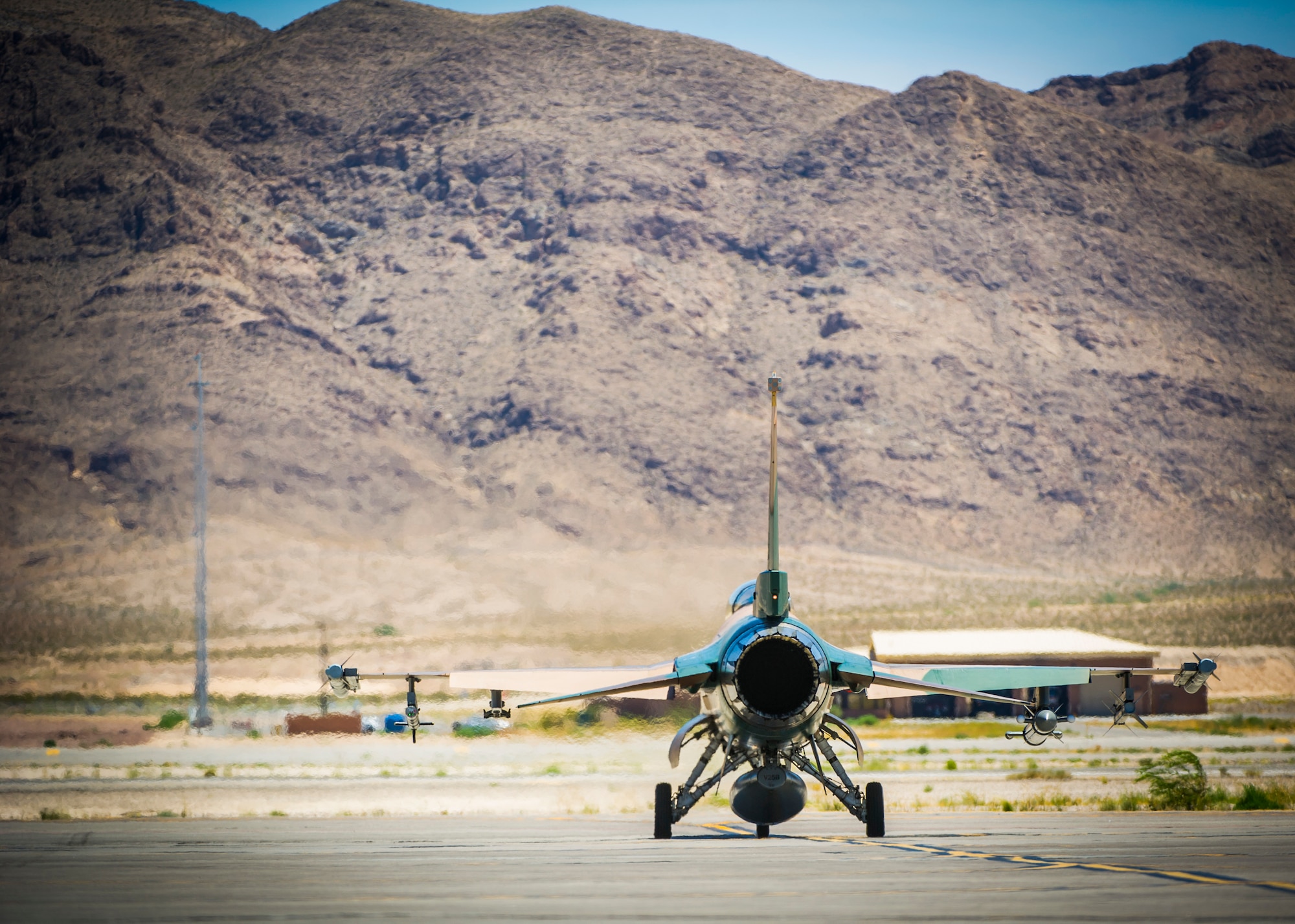 An F-16 fighting falcon assigned to the 64th Aggressors Squadron taxis on the runway July 16, 2019, at Nellis Air Force Base, Nev. Historically, temperatures at Nellis have reached over 118 degrees Fahrenheit. Red Flag focuses on the application of core missions to include Command and Control, Intelligence Surveillance, Strike and Personnel Recovery and how to work with Coalition counterparts to ensure success. The 706th Fighter Squadron oversees Air Force Reserve Command members assigned to the U.S. Air Force Warfare Center, supporting missions in its 57th Wing, 53rd Wing and 505th Command and Control Wing. Pilots assigned to the 706 FS fly an array of aircraft to include the F-15C, F-15E, F-16, F-22 and F-35 aircraft. To prepare combat air forces, joint and allied crews with realistic training, pilots in the 706 FS operate with the 64th Aggressor Squadron to facilitate operational threat replication, training, and feedback. The Red Flag exercise will continue through July 26, 2019.