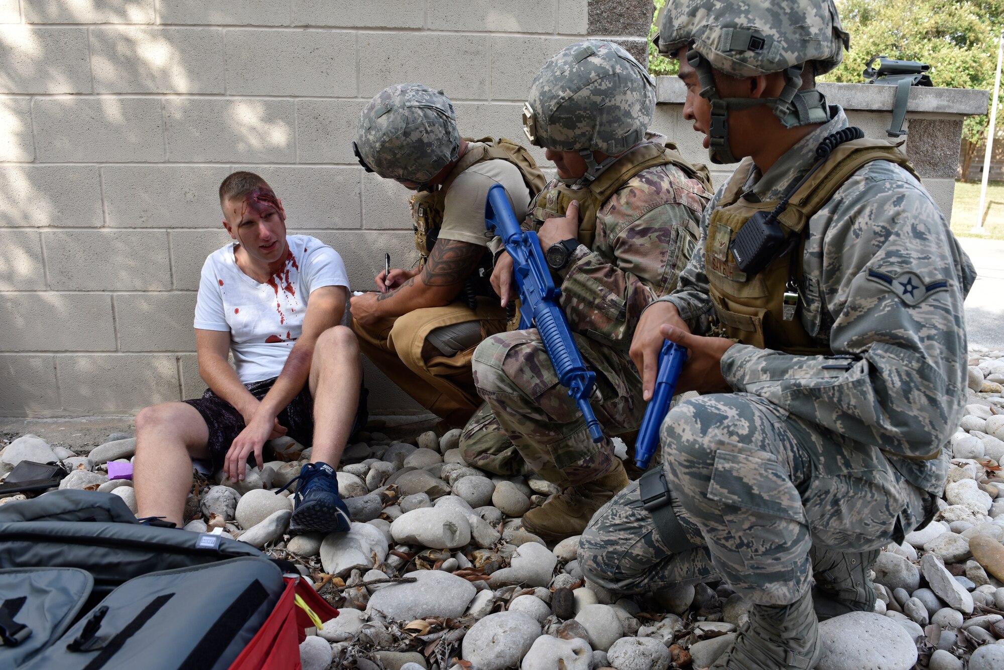 Members of the 47th Security Forces Squadron interviews a simulated active shooter victim during a training exercise at Laughlin Air Force Base, Texas, July 22, 2019. The exercise, aimed at bolstering crisis readiness and response capabilities, simulated a hostage situation that lasted for nearly two hours. (U.S. Air Force photo by Staff Sgt. Benjamin N. Valmoja)