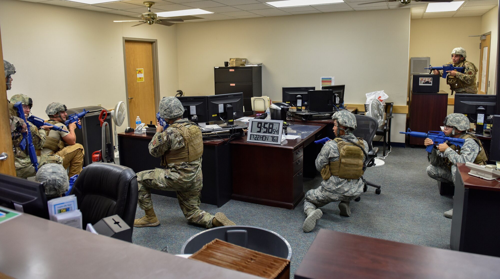 Members of the 47th Security Forces Squadron prepare to recover simulated hostages during a training exercise at Laughlin Air Force Base, Texas, July 22, 2019. A simulated suspect barricaded himself in a small room and tested the defenders’ ability to respond to a hostage situation. Exercises like this one are aimed at bolstering crisis readiness and response capabilities. (U.S. Air Force photo by Staff Sgt. Benjamin N. Valmoja)