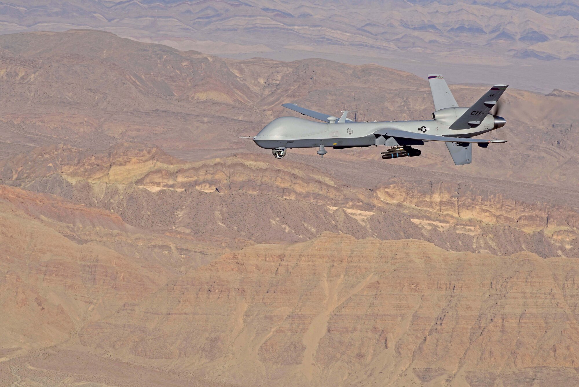 An MQ-9 Reaper, piloted from the ground by Maj. Stevo, MQ-9 instructor pilot, flies over the Nevada Test and Training Range, July 15, 2019. Remotely Piloted Aircraft Airmen are responsible for providing dominant, persistent attack capabilities for our nation and its allies across the globe. (U.S. Air Force photo by Senior Airman Haley Stevens)