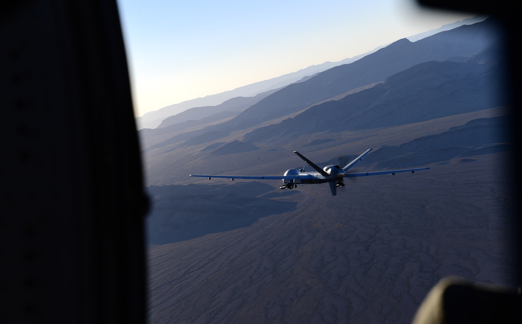 An MQ-9 Reaper, piloted from the ground by Maj. Stevo, MQ-9 instructor pilot, flies over the Nevada Test and Training Range, July 15, 2019. Airmen stationed at Creech Air Force Base support local training missions and long-range combat missions in various areas of responsibility 24/7/365. (U.S. Air Force photo by Senior Airman Haley Stevens)