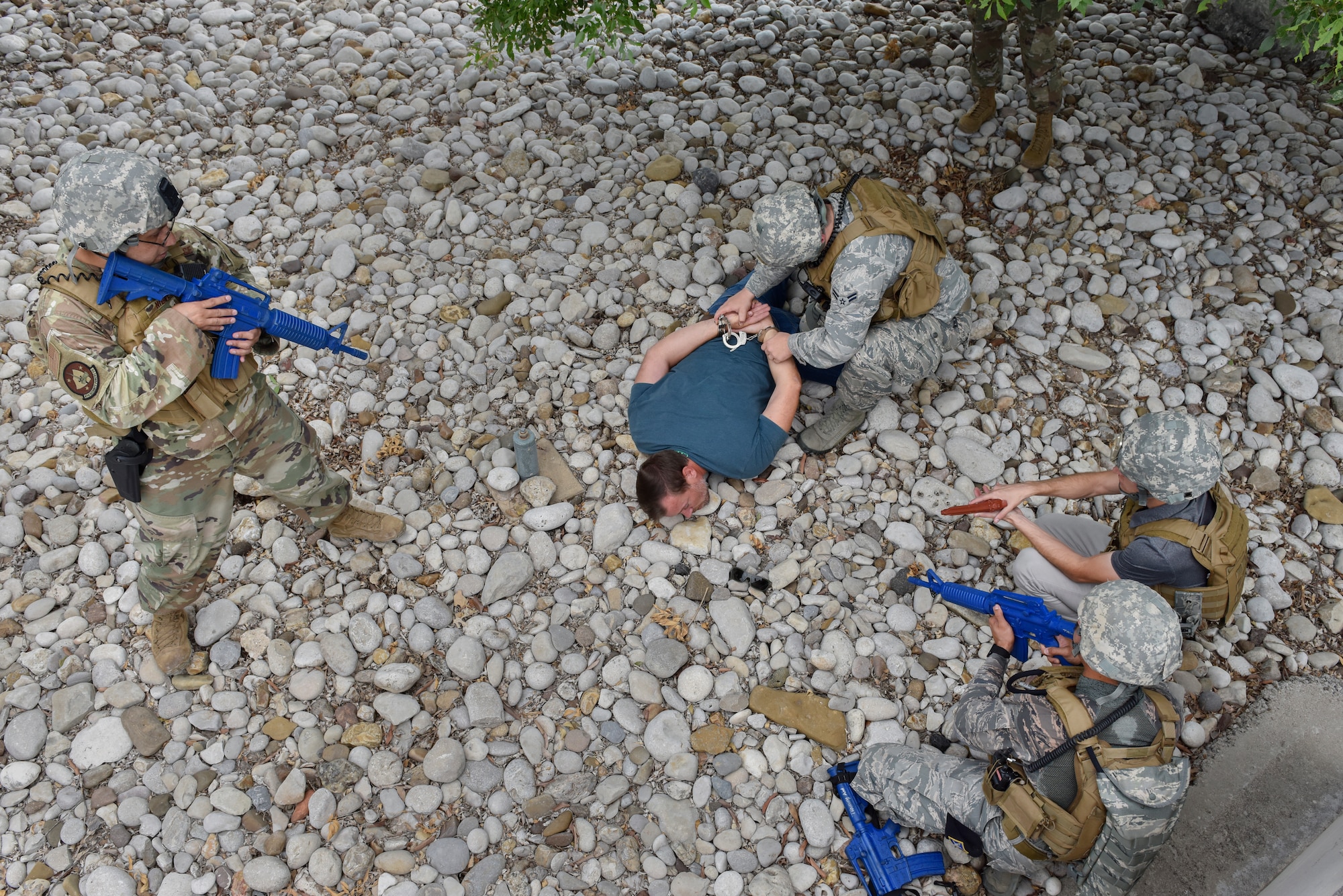 Members of the 47th Security Forces Squadron apprehend a simulated active shooter suspect during a training exercise at Laughlin Air Force Base, Texas, July 22, 2019. After negotiating, the defenders managed to bring down the pseudo suspect in a simulated hostage situation. The exercise was aimed at bolstering crisis readiness and response capabilities. (U.S. Air Force photo by Staff Sgt. Benjamin N. Valmoja)