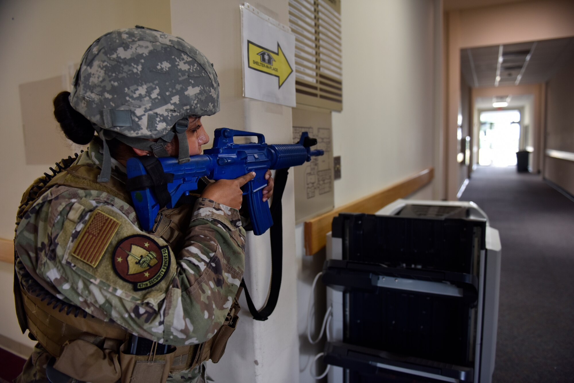Staff Sgt. Desiree Gonzalez, 47th Security Forces Squadron police services NCO in charge, locks down an entry control point during a training exercise at Laughlin Air Force Base, Texas, July 22, 2019. The exercise, aimed at bolstering crisis readiness and response capabilities, simulated a hostage situation that lasted for nearly two hours. (U.S. Air Force photo by Staff Sgt. Benjamin N. Valmoja)