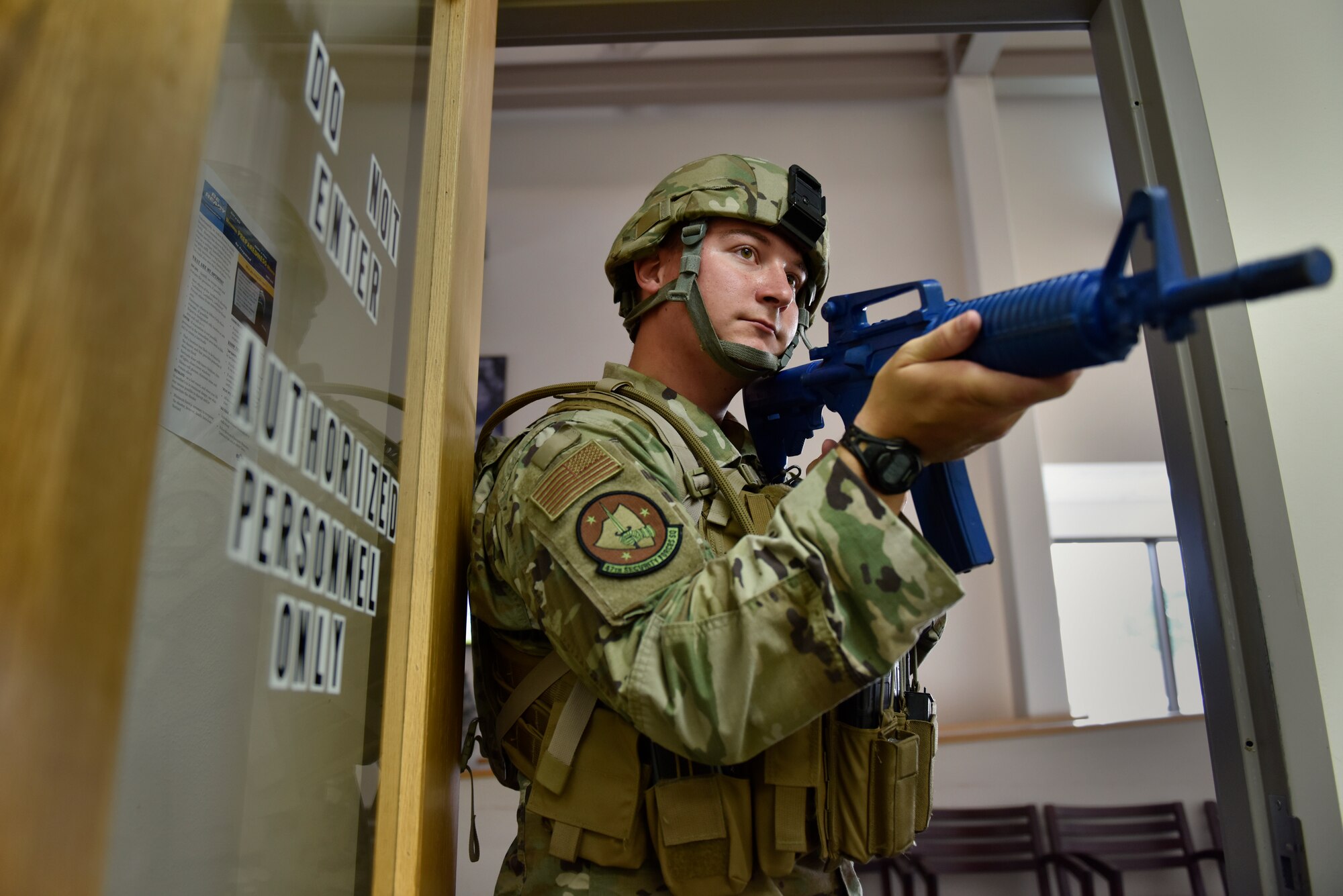 Senior Airman Alexander Larson stands watch during an active shooter training at Laughlin Air Force Base, Texas, July 22, 2019. The exercise, aimed at bolstering crisis readiness and response capabilities, simulated a hostage situation that lasted for nearly two hours. (U.S. Air Force photo by Staff Sgt. Benjamin N. Valmoja)